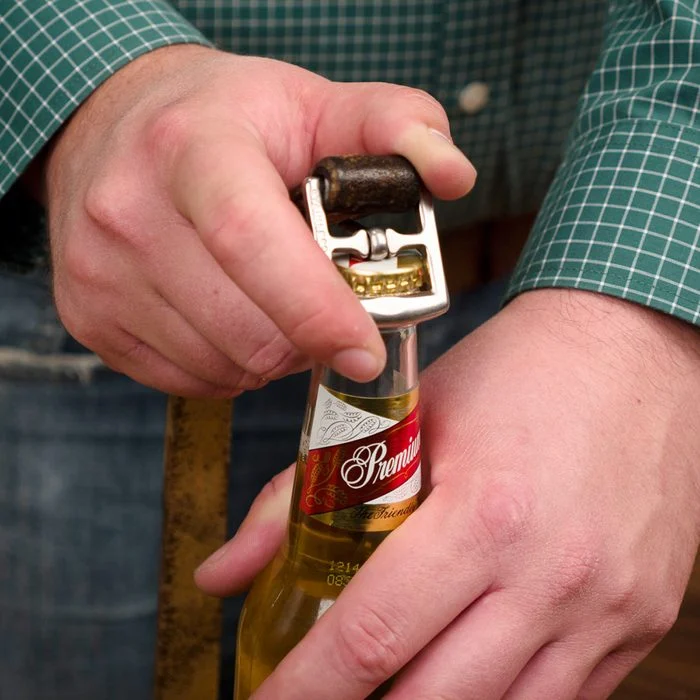 Use a belt buckle to open the bottle